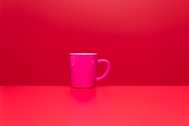 istock Pink color coffee or tea cup on red background 1306532165