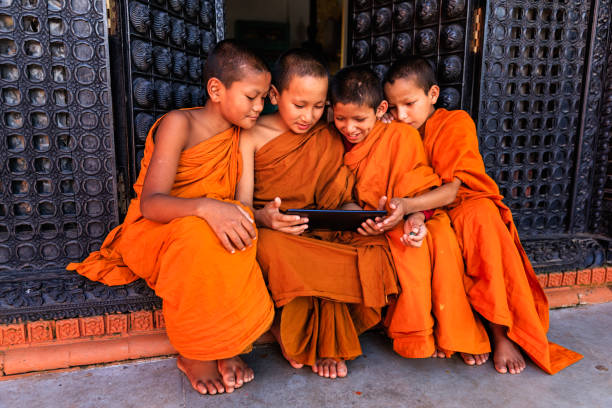 Novice Buddhist monks using digital tablet in the monastery in Bhaktapur, Nepal