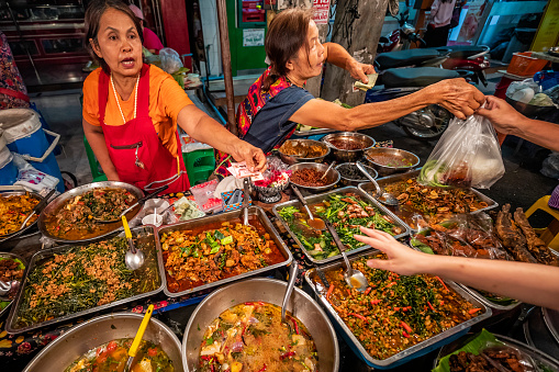 Thai street food seller at the night market in Chiang Mai, Northern Thailand