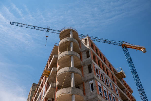 istock Construction tower cranes on a building site against the sky stock photo 1306532404