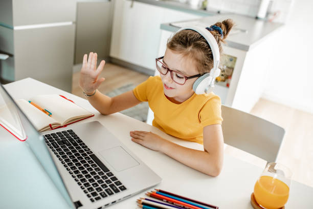istock A little girl attending online classes at home 1306534717