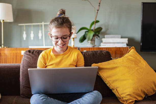 istock Little girl is using laptop at home 1306534719