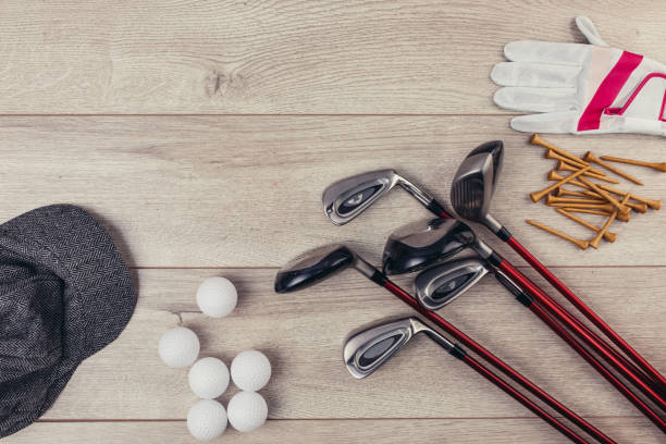 istock Golf equipment on wooden table background 1306535285