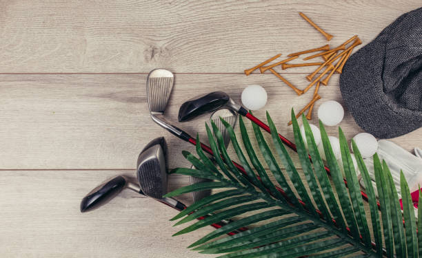 istock Golf equipment on wooden table background 1306535387