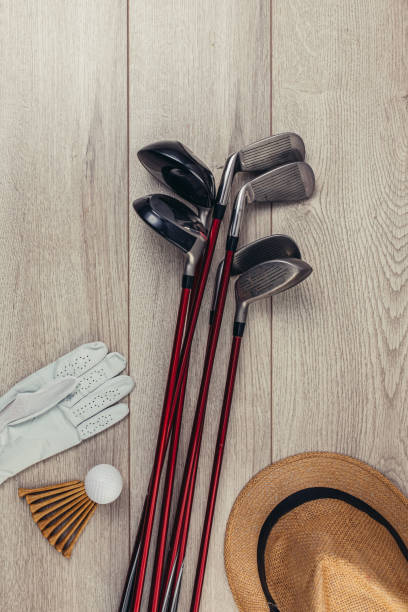 istock Golf equipment on wooden table background 1306535410