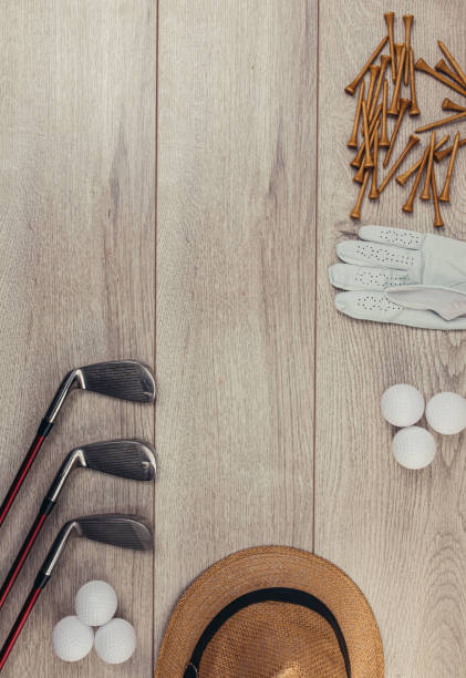 istock Golf equipment on wooden table background 1306535510