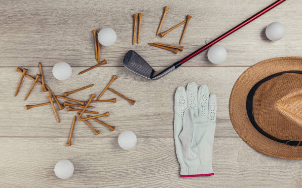 istock Golf equipment on wooden table background 1306536179
