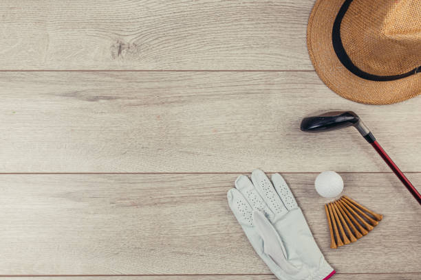 istock Golf equipment on wooden table background 1306536207