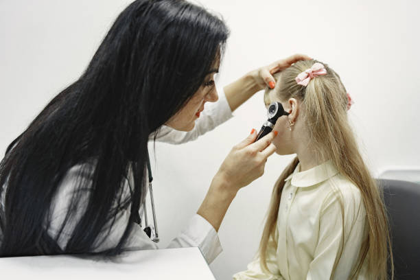 istock Doctor examines girl's ears with a tool 1306539100