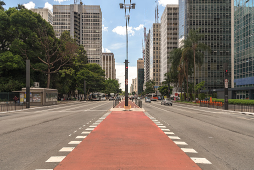 Street view of one of the busiest avenue, and one of the symbols of the city of São Paulo, Avenida Paulista, with its cars and bicycles