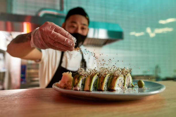 istock Chef preparing sushi in an Asia restaurant 1306540760