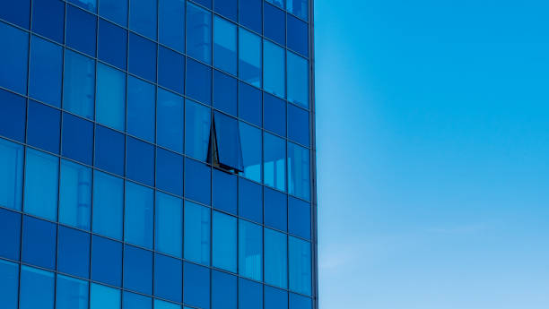 istock Abstract modern building background for design. Office building window close-up. Blue sky background. 1306541697