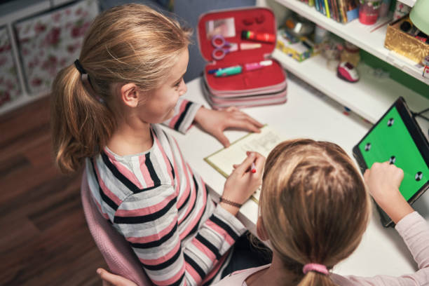 istock Little Girls Doing Home Schooling with Tablet Green Screen 1306542870