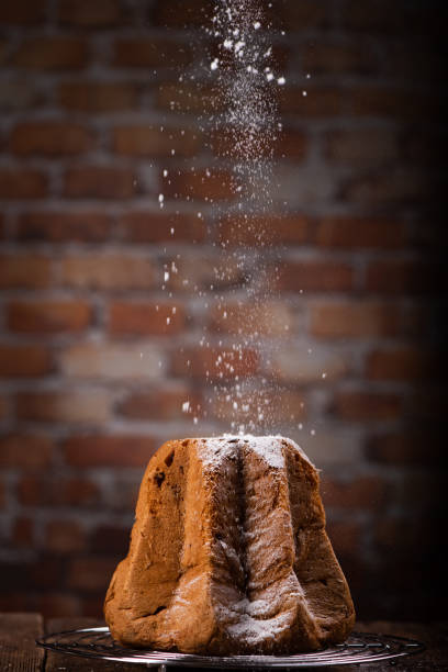 istock Pandoro with dusting of icing sugar on dark background. 1306544370