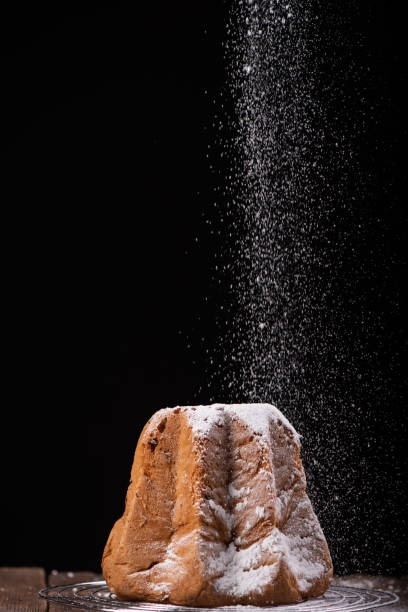istock Pandoro with dusting of icing sugar on dark background. 1306544393