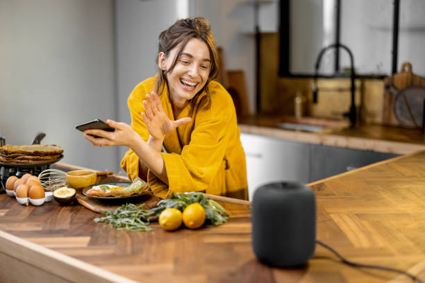istock Woman speaking to a smart speaker during a breakfast at home 1306545097