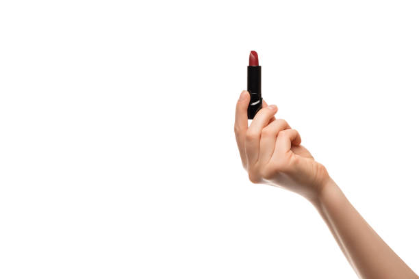 istock Red lipstick in a woman's hand on a white background, isolated. 1306546709