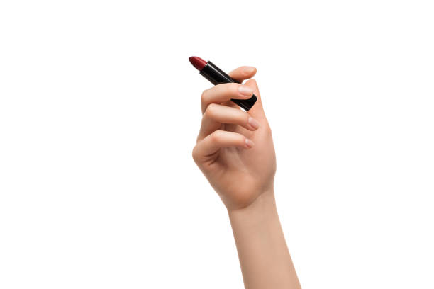 istock Red lipstick in a woman's hand on a white background, isolated. 1306546711