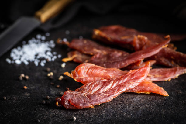 istock Dried chicken meat. Tasty jerky meat. 1306546717