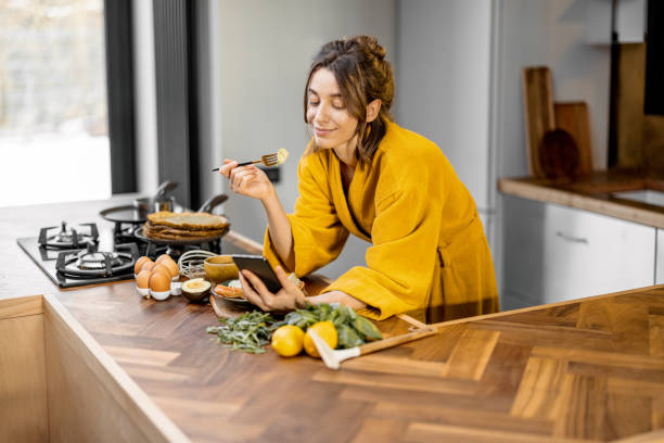 istock Woman enjoys breakfast on the kitchen in the morning 1306546749