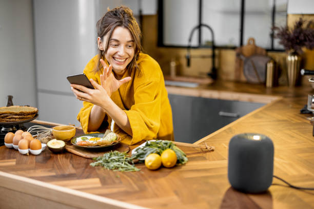istock Woman speaking to a smart speaker during a breakfast at home 1306547655