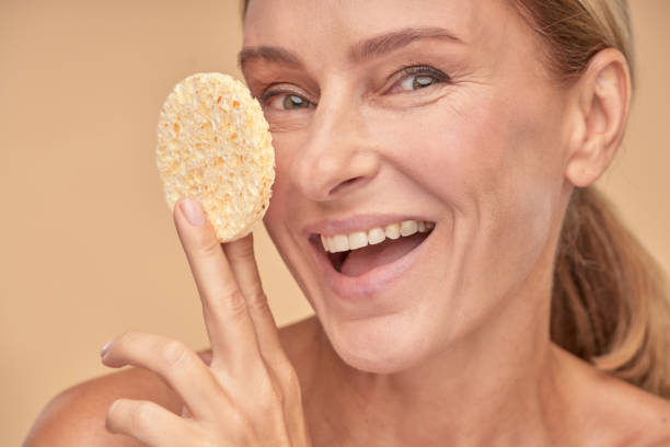 istock Happy adult lady going to remove make up from her face 1306547776