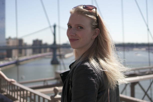 istock Girl posing infront of brooklyn bridge 1306548034