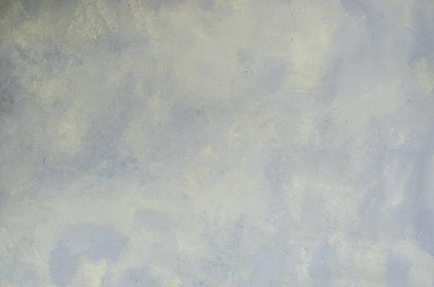 istock Abstract textured cloth gray background with blurred yellow spots. 1306548184