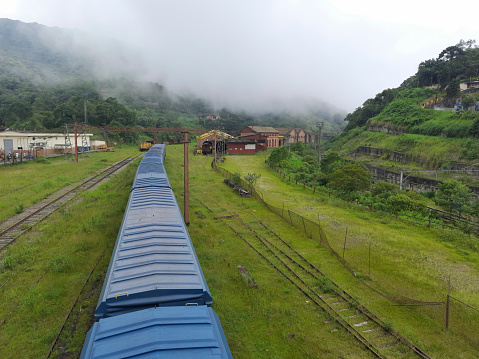 Freighter train passes through the fog at Paranapiacaba railway terminal in southeastern Brazil