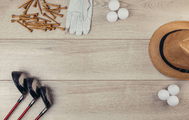 istock Golf equipment on wooden table background 1306551684