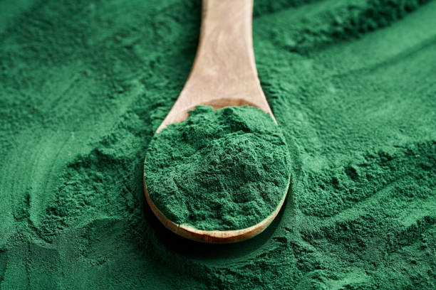 istock Fresh spirulina powder on a wooden spoon 1306551854