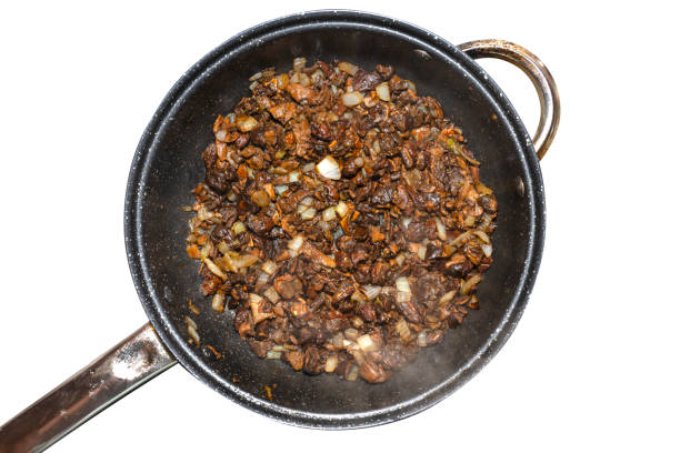 istock Mushrooms fried whole in a pan with onions, isolated on a white background with a clipping path. 1306552544