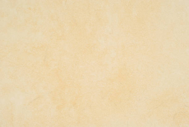 istock Plaster on a yellow wall. Concrete wall texture close up. 1306555188