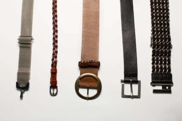 istock Leather and metal belts isolated on a white background 1306557423
