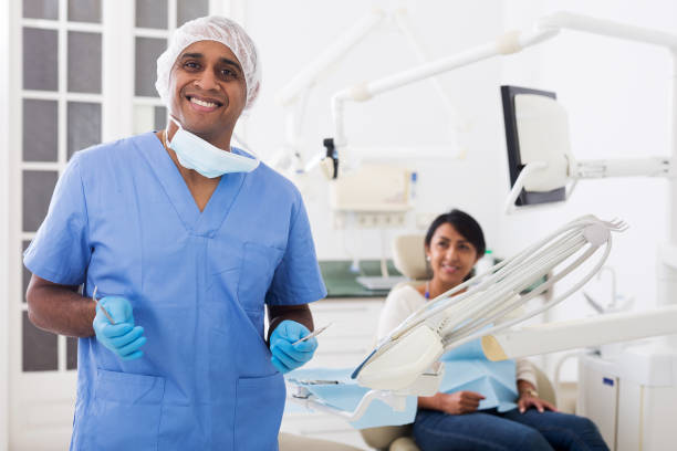istock Smiling qualified stomatologist posing at dental office 1306558831