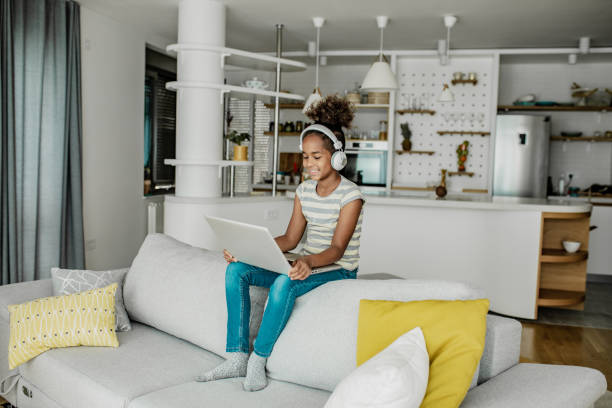 istock Young girl is using laptop at home 1306560956
