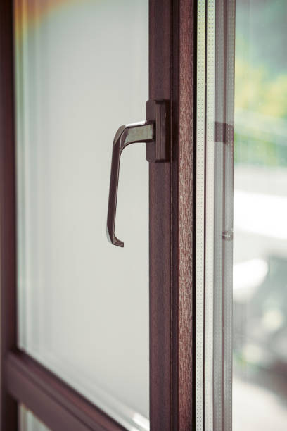 Brown handle of modern plastic window. Closeup shot