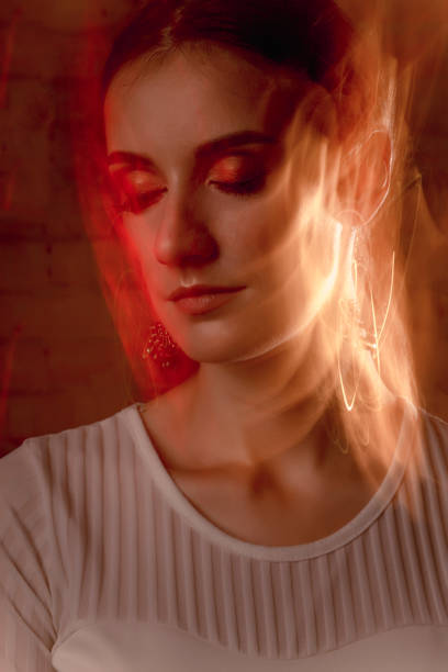 istock Closeup portrait of pretty model in mixed light at studio 1306561809