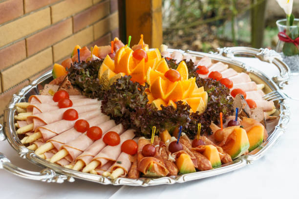 istock Summer buffet with orange, tomatoes, ham and asparagus 1306562978