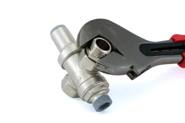 istock Water pressure reducer with a wrench isolated on a white background 1306563005