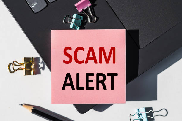 istock SCAM ALERT note is written on a paper sticker on a laptop keyboard. 1306564682