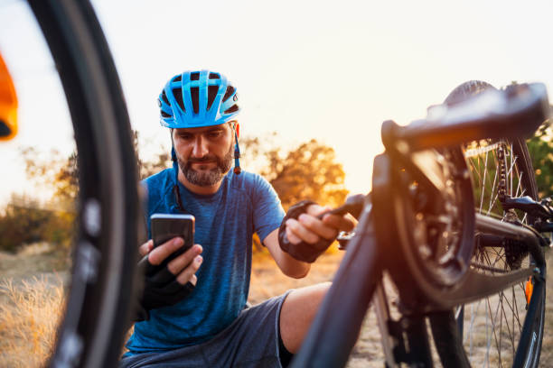 istock Male biker watching a tutorial on the phone while repairing his bike 1306566687