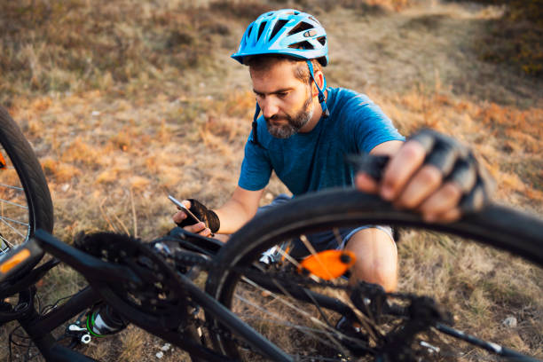 istock High angle view of a man repairing his bike and watching tutorials on the internet for tips 1306566695