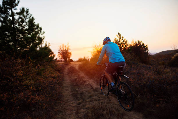 istock Male biker is riding on a dirt road 1306566705