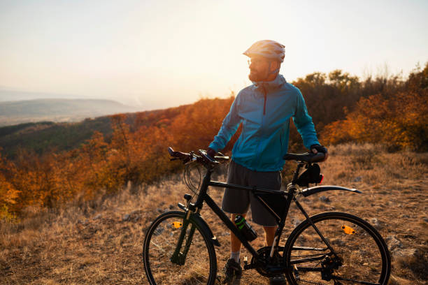 istock Man cyclist resting and looking at the nature view 1306566727