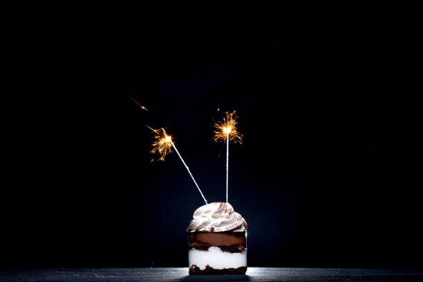 istock Chocolate and Raspberry Birthday Cake with Sparkler on Dark Background 1306567880