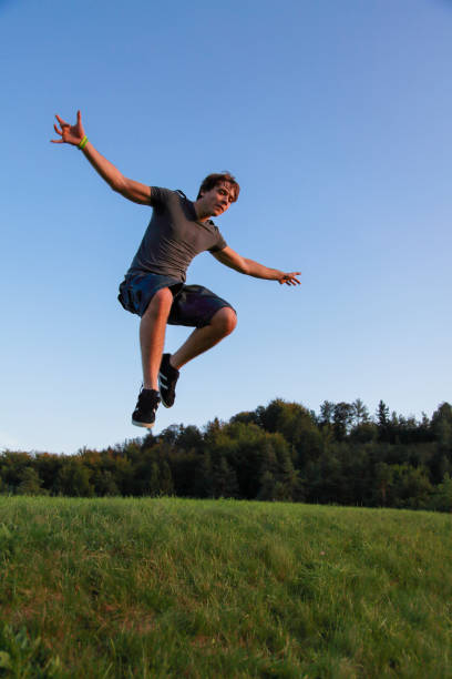 istock Man jumping on grassland hill top 1306569121