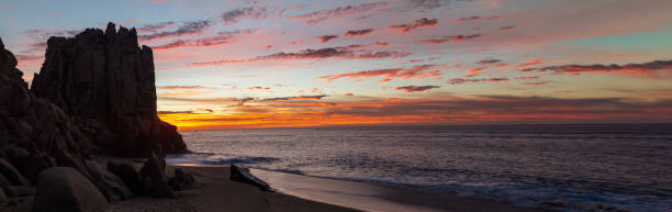 istock Panoramic dramatic sunrise on the beach at Cabo San Lucas, Mexico. 1306570170