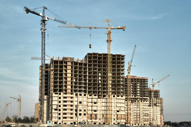 istock Construction site with buildings and cranes at blue sky background 1306573829