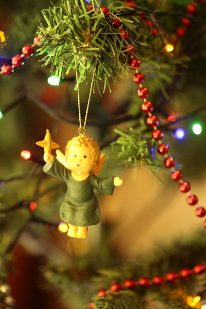 A little angel decoration on a Christmas tree.